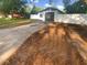 View of home exterior, displaying a driveway and fenced yard at 1736 Taylor Lake Pl, Largo, FL 33778