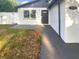 Charming home featuring a white exterior with a dark door and well-maintained yard at 1736 Taylor Lake Pl, Largo, FL 33778