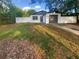 Charming single-story home featuring a freshly painted exterior, dark gray accents, and an attached garage at 1736 Taylor Lake Pl, Largo, FL 33778