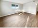 Bright living room with wood-look flooring and a window providing natural light at 1736 Taylor Lake Pl, Largo, FL 33778