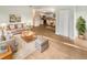 Open-concept living room boasts hardwood floors, neutral paint, and ample natural light at 1736 Taylor Lake Pl, Largo, FL 33778