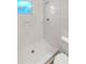 Bright shower area with all-white tile at 1736 Taylor Lake Pl, Largo, FL 33778