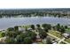 Aerial view showcases the property's proximity to a lake, emphasizing a serene and picturesque neighborhood setting at 3565 E Lake Dr, Land O Lakes, FL 34639