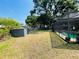 Enjoy a spacious backyard with a shed, screened pool, and plenty of space for outdoor activities at 3565 E Lake Dr, Land O Lakes, FL 34639