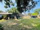 The property features a screened pool, storage shed, and plenty of space for outdoor activities at 3565 E Lake Dr, Land O Lakes, FL 34639