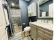 A beautifully renovated bathroom with a marble vanity, updated fixtures, and elegant tiled shower with seat at 3565 E Lake Dr, Land O Lakes, FL 34639
