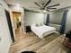 This bedroom features sleek wood floors, a large ceiling fan, and soothing grey walls with natural vine accents at 3565 E Lake Dr, Land O Lakes, FL 34639