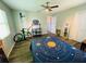 Bedroom with bed, ceiling fan, wood flooring, and natural light perfect for relaxation and personal space at 3565 E Lake Dr, Land O Lakes, FL 34639