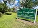 Lake Padgett Estates sign in a lush green field highlighting the waterfront community at 3565 E Lake Dr, Land O Lakes, FL 34639
