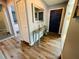 Stylish entryway with hardwood floors, a decorative mirror, and access to the living spaces and bedrooms at 3565 E Lake Dr, Land O Lakes, FL 34639