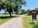 A view of the equestrian center with horses grazing in the background on a sunny day at 3565 E Lake Dr, Land O Lakes, FL 34639
