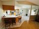 Cozy kitchen featuring a breakfast bar, modern appliances, and tiled flooring at 3565 E Lake Dr, Land O Lakes, FL 34639