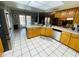 Spacious kitchen featuring stainless steel appliances, a breakfast bar, and tiled flooring at 3565 E Lake Dr, Land O Lakes, FL 34639