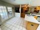Bright kitchen with an open view of the living room and access to the outdoor pool area at 3565 E Lake Dr, Land O Lakes, FL 34639