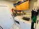 Laundry room with washer, dryer, overhead storage and door to the left at 3565 E Lake Dr, Land O Lakes, FL 34639