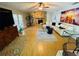 Bright living room featuring a stone fireplace, ceiling fan, and stylish contemporary furniture at 3565 E Lake Dr, Land O Lakes, FL 34639