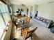 Open concept living space featuring a dining table, desk and gray sofa at 3565 E Lake Dr, Land O Lakes, FL 34639
