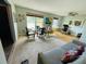 Combined living space with both carpet and wood flooring and multiple windows at 3565 E Lake Dr, Land O Lakes, FL 34639