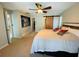 This main bedroom features a large bed, ceiling fan and artwork on the walls at 3565 E Lake Dr, Land O Lakes, FL 34639