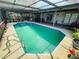 Relax by this screened-in swimming pool, perfect for year-round enjoyment and outdoor entertaining in style at 3565 E Lake Dr, Land O Lakes, FL 34639