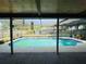 A sparkling pool with a screened enclosure is ready for relaxation and entertaining in a private backyard setting at 3565 E Lake Dr, Land O Lakes, FL 34639