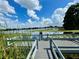 Gorgeous lake view with lush green vegetation and clear blue skies and fluffy white clouds at 3565 E Lake Dr, Land O Lakes, FL 34639