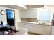 Kitchen featuring white cabinetry, stainless steel sink, and a window for natural light at 4719 Alcazar S Way, St Petersburg, FL 33712