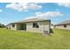Backyard featuring green grass, new construction, and views of the property's exterior at 13828 Richland Gulf Cir, Parrish, FL 34219