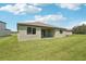 The backyard features a grassy lawn and a concrete patio area at 13828 Richland Gulf Cir, Parrish, FL 34219
