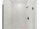This bathroom features an updated shower with black hardware and marble tiling at 13828 Richland Gulf Cir, Parrish, FL 34219