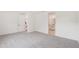 Neutral bedroom with carpet floors and ensuite bathroom entrance at 13828 Richland Gulf Cir, Parrish, FL 34219