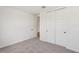 Clean bedroom with carpet, closet, and a view to the hallway at 13828 Richland Gulf Cir, Parrish, FL 34219