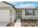 This beautiful home includes a charming front entrance with lovely landscaping at 13828 Richland Gulf Cir, Parrish, FL 34219