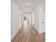 This hallway has a wood floor and white walls and plenty of room to move at 13828 Richland Gulf Cir, Parrish, FL 34219