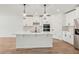 Modern kitchen features stainless steel appliances, a central island and pendant lighting at 13828 Richland Gulf Cir, Parrish, FL 34219