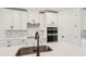 Stylish kitchen featuring white cabinets, stainless steel appliances, and sleek countertops at 13828 Richland Gulf Cir, Parrish, FL 34219