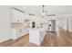 Bright kitchen features all-white cabinetry, stainless appliances, backsplash and an island at 13828 Richland Gulf Cir, Parrish, FL 34219