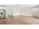 The living room has wood flooring, a white interior, and open spaces at 13828 Richland Gulf Cir, Parrish, FL 34219