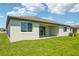 A covered patio and lush green lawn create a relaxing backyard oasis at 1780 Draughton Dr, Zephyrhills, FL 33541