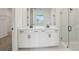 Bathroom with double vanity, modern fixtures, and walk-in shower with glass enclosure at 1780 Draughton Dr, Zephyrhills, FL 33541