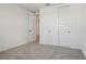 Carpeted bedroom featuring a closet with paneled doors, allowing for ample storage at 1780 Draughton Dr, Zephyrhills, FL 33541