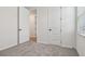 Bedroom featuring plush carpeting and a white door at 1780 Draughton Dr, Zephyrhills, FL 33541