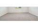 Bedroom featuring plush carpeting and a window for natural light at 1780 Draughton Dr, Zephyrhills, FL 33541