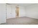 A spacious bedroom with neutral carpet and an open doorway leading to the attached bathroom at 1780 Draughton Dr, Zephyrhills, FL 33541