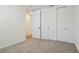 Bedroom featuring plush carpeting and a double door closet for ample storage at 1780 Draughton Dr, Zephyrhills, FL 33541