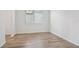 Bright bedroom with wood-look tile flooring and natural light from a window at 1780 Draughton Dr, Zephyrhills, FL 33541