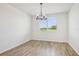 Bright dining room with modern chandelier and large window with outdoor view at 1780 Draughton Dr, Zephyrhills, FL 33541