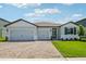 Charming single-Gathering home boasts a manicured lawn and brick-paved driveway at 1780 Draughton Dr, Zephyrhills, FL 33541