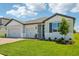 Inviting exterior view of a single-Gathering home with a well-maintained lawn at 1780 Draughton Dr, Zephyrhills, FL 33541