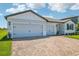 Beautiful single-Gathering home featuring a two-car garage and a brick-paved driveway at 1780 Draughton Dr, Zephyrhills, FL 33541